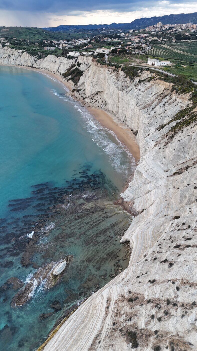 White cliffs and turquoise sea under a storm sky, Cappiddrazzu, Sicily